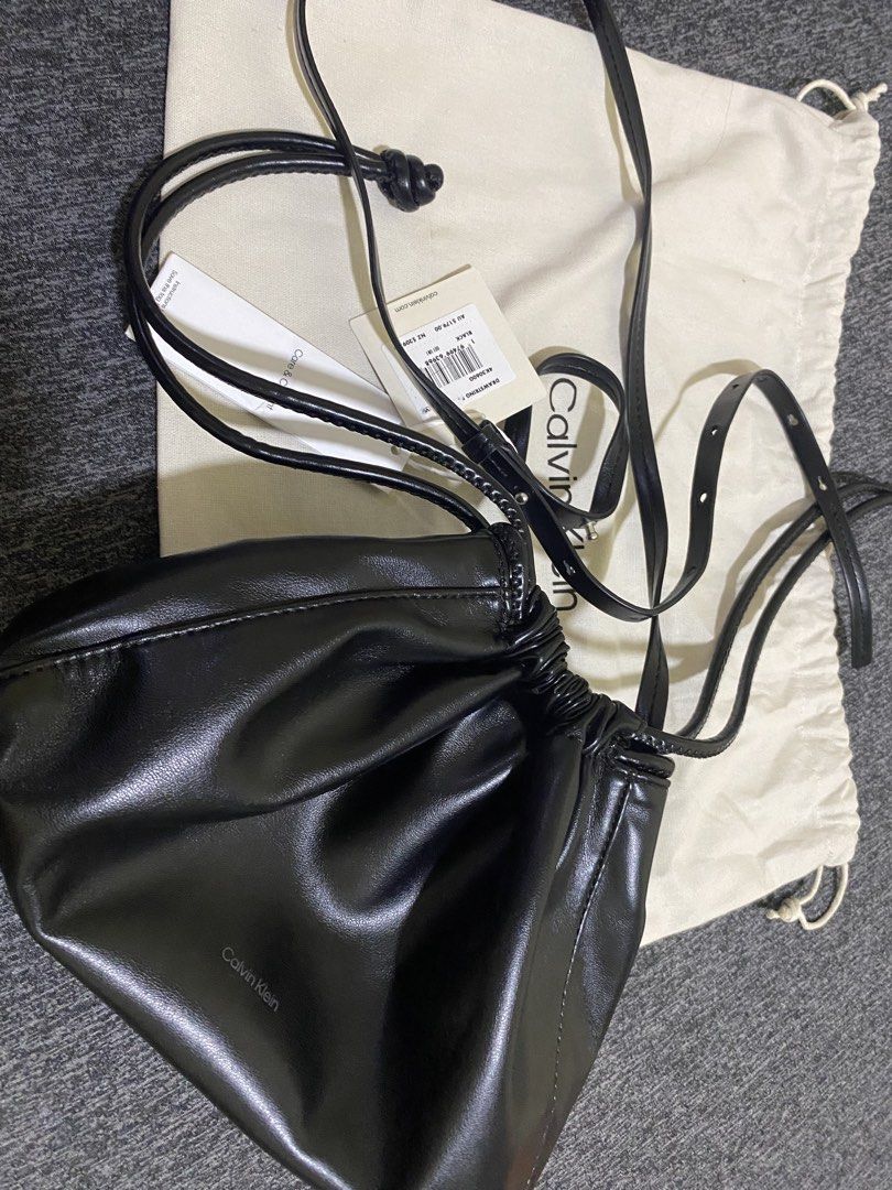 CALVIN KLEIN DRAWSTRING BAG (Category: Luxury Bags & Wallets) located in Angeles City. Submitted by euniciaaa (Listing ID 1466383038, Image 2). Description: Calvin Klein Color: Black Material: Soft faux leather Closure: Drawstring closure Strap: Adjustable thin strap for crossbody or shoulder wear Inclusion: Original white Calvin Klein dust bag included, Tag, Care & Content .
