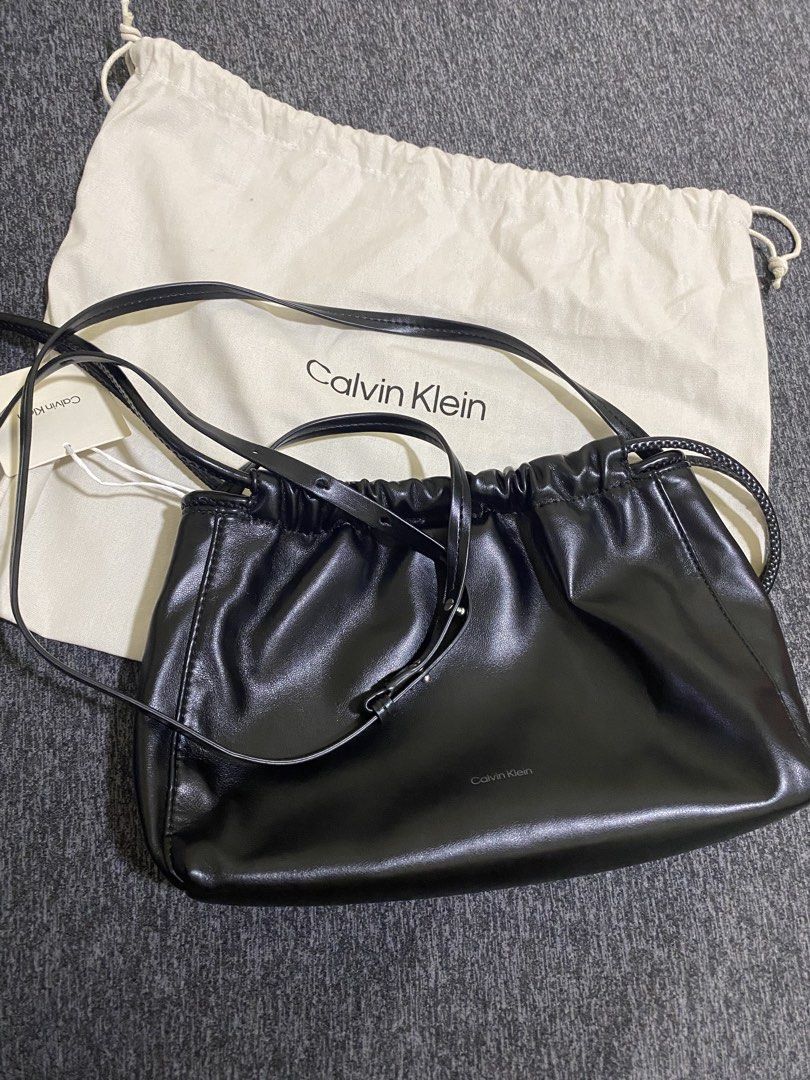 CALVIN KLEIN DRAWSTRING BAG (Category: Luxury Bags & Wallets) located in Angeles City. Submitted by euniciaaa (Listing ID 1466383038, Image 3). Description: Calvin Klein Color: Black Material: Soft faux leather Closure: Drawstring closure Strap: Adjustable thin strap for crossbody or shoulder wear Inclusion: Original white Calvin Klein dust bag included, Tag, Care & Content .