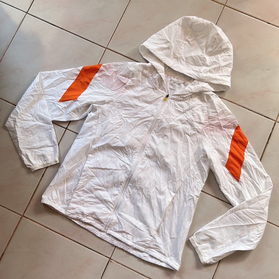 Calvin Klein Performance Windbreaker Jacket 🔥 (Category: Coats, Jackets and Outerwear) located in Jinoba-an. Submitted by eegiboy (Listing ID 1466426631, Image 3). Description: - Brand: Calvin Klein Performance - Color: White with bright orange sleeve accents - Size: Small dimes: 18/23 - Material: Lightweight perforated fabric for breathability - Design: Front zip closure with a pop of yellow zipper pull, hooded style - Branding: Calvin Klein lo