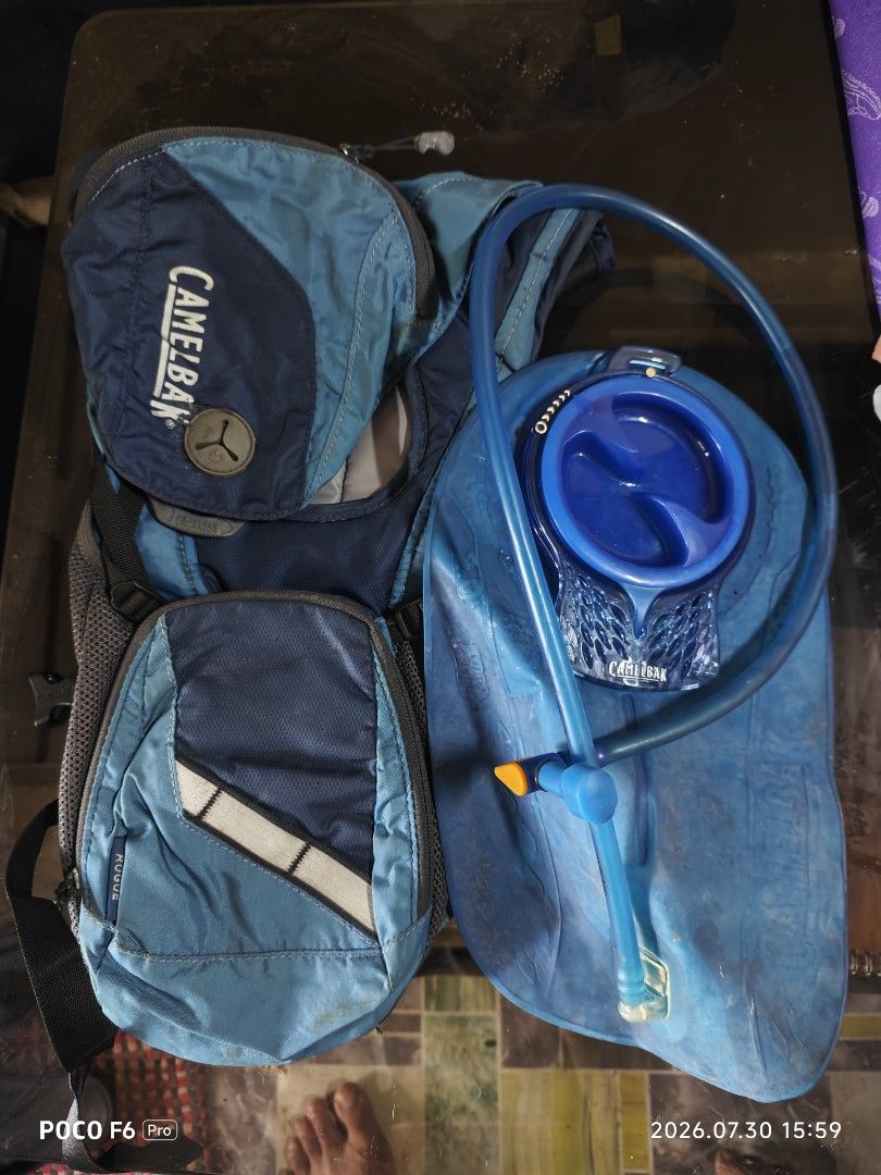 Camelbak Rogue Hydration Backpack (Category: Backpacks) located in Manila. Submitted by eseblud (Listing ID 1466506868, Image 1). Description: Blue Camelbak Rogue hydration backpack including the matching blue water bladder and drinking tube. Blue and dark blue colorway with mesh backing and reflective strap detail. Great for cycling, running, and mountain biking. Used gear with some signs of wear on the fabric and bladder, but fully functional..