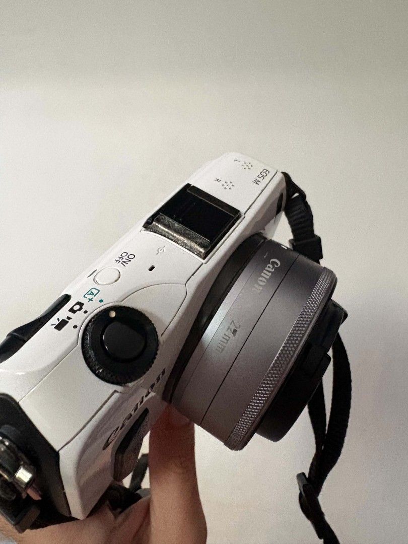 Canon EOS M White (Category: Cameras) located in Taguig. Submitted by cam_demigod (Listing ID 1466459195, Image 2). Description: - Model: Canon EOS M Mirrorless Camera (White) - Lens: EF-M 22mm f/2 pancake lens with cap - Power: Wasabi Power dual battery charger included - Features: Compact and lightweight, perfect for everyday carry and street photography - Condition: Ready to shoot with strap attached.