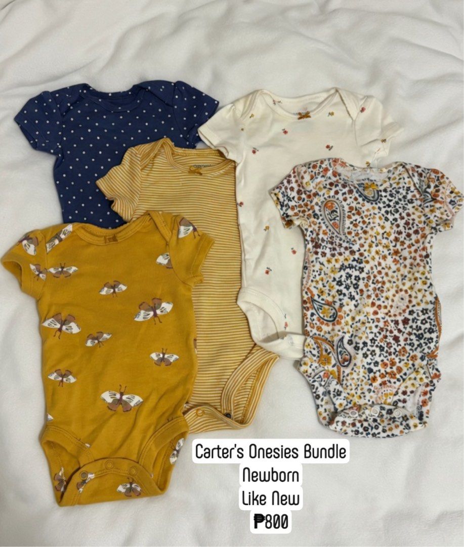 Carter's Onesies Bundle Newborn (Category: Babies & Kids Fashion) located in Makati City. Submitted by max_lilo (Listing ID 1466398068, Image 1). Description: - Brand: Carter's - Size: Newborn - Quantity: Bundle of 5 short-sleeve onesies - Designs: Butterflies, stripes, polka dots, and florals - Material: Soft, breathable cotton - Features: Convenient bottom snap closures for easy diaper changes.
