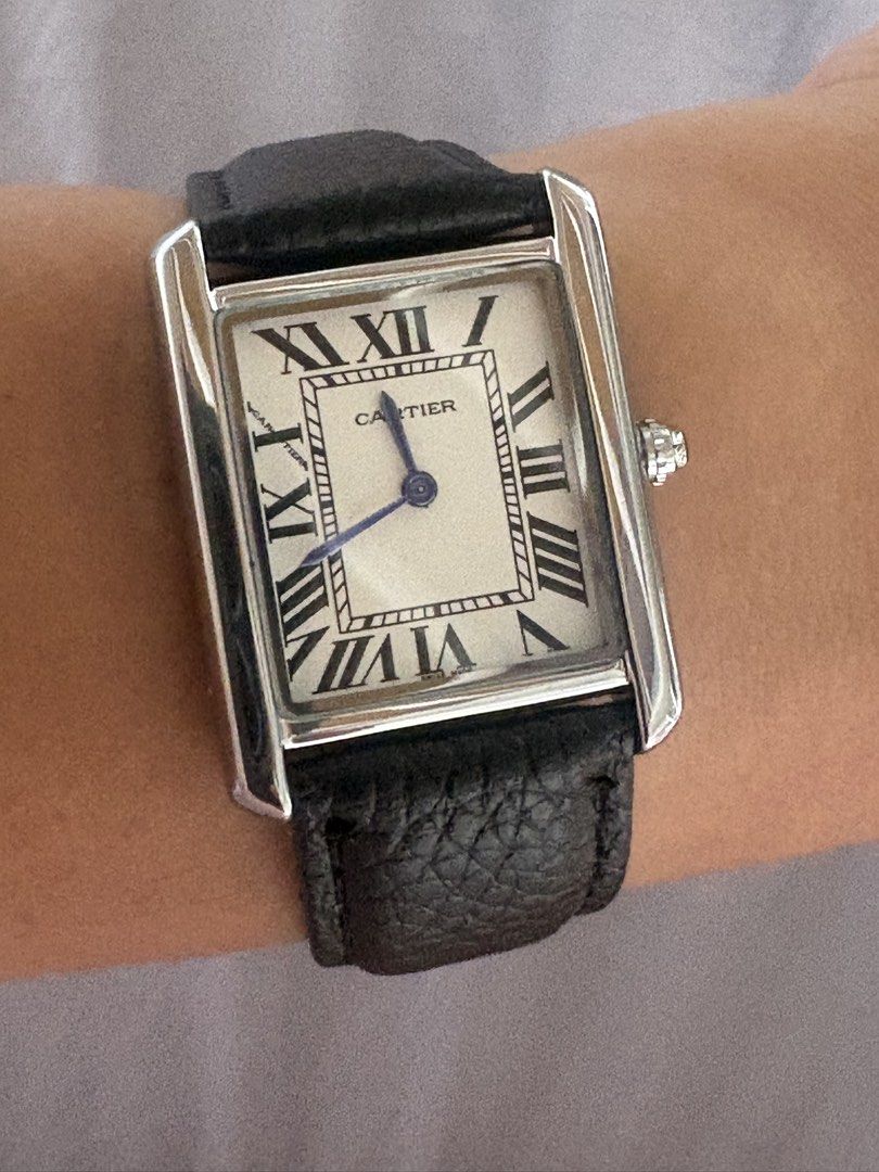 Cartier Tank Watch (Category: Men's Watches) located in Manila. Submitted by mndoxajc (Listing ID 1466064786, Image 2). Description: - Model: Cartier Tank watch - Movement: Battery-operated quartz - Dial: Classic white with Roman numerals and a clean, scratch-free crystal face - Case: Silver-tone stainless steel with stamped Cartier markings, serial numbers, and water-resistance text on the back - Strap: Black textured leather strap with a secure
