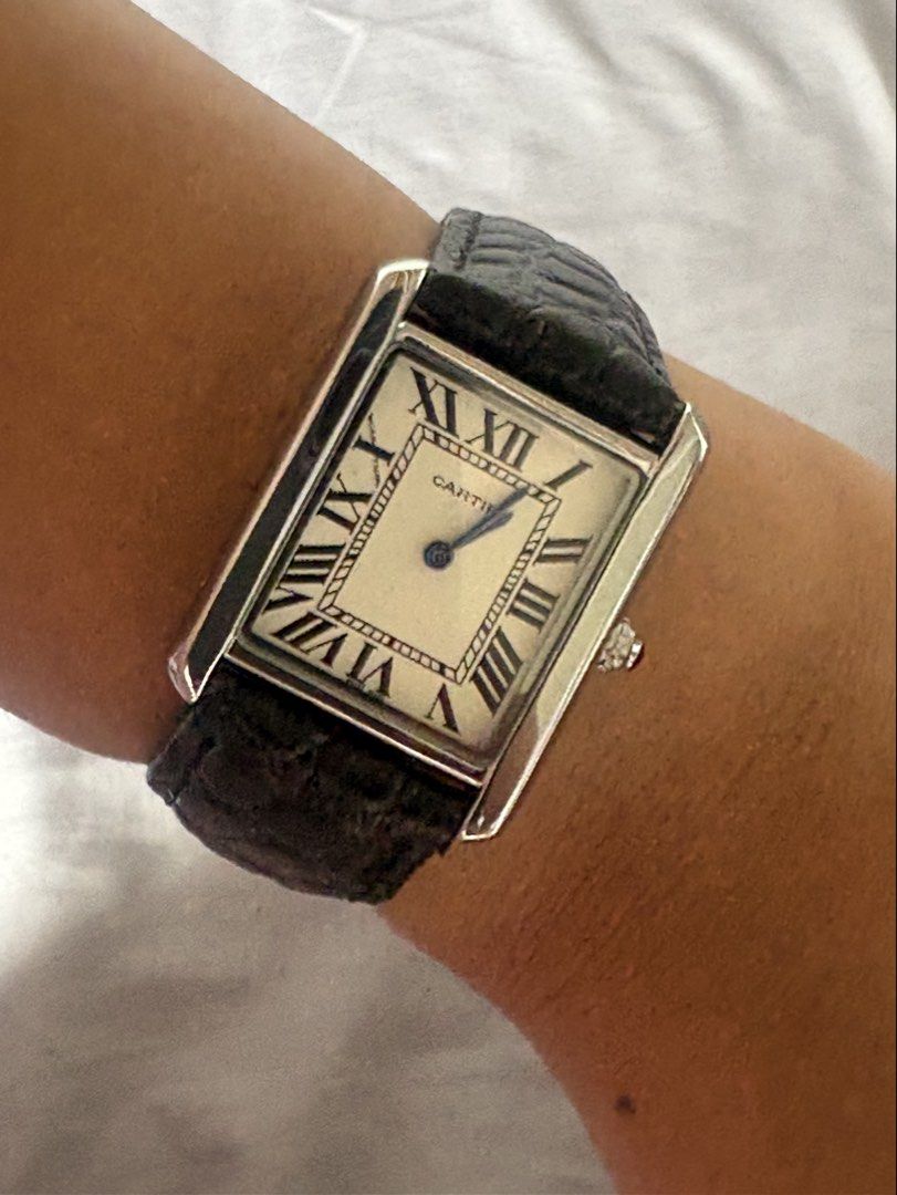 Cartier Tank Watch (Category: Men's Watches) located in Manila. Submitted by mndoxajc (Listing ID 1466064228, Image 1). Description: Stainless steel Cartier Tank watch with white dial and Roman numerals. Black embossed leather strap attached. Blue hands and blue cabochon crown. Case back engraved with Cartier, water resistant, swiss made, stainless steel, and model number 216. Genuine leather stamped on the inner strap. Minimal signs of wear..