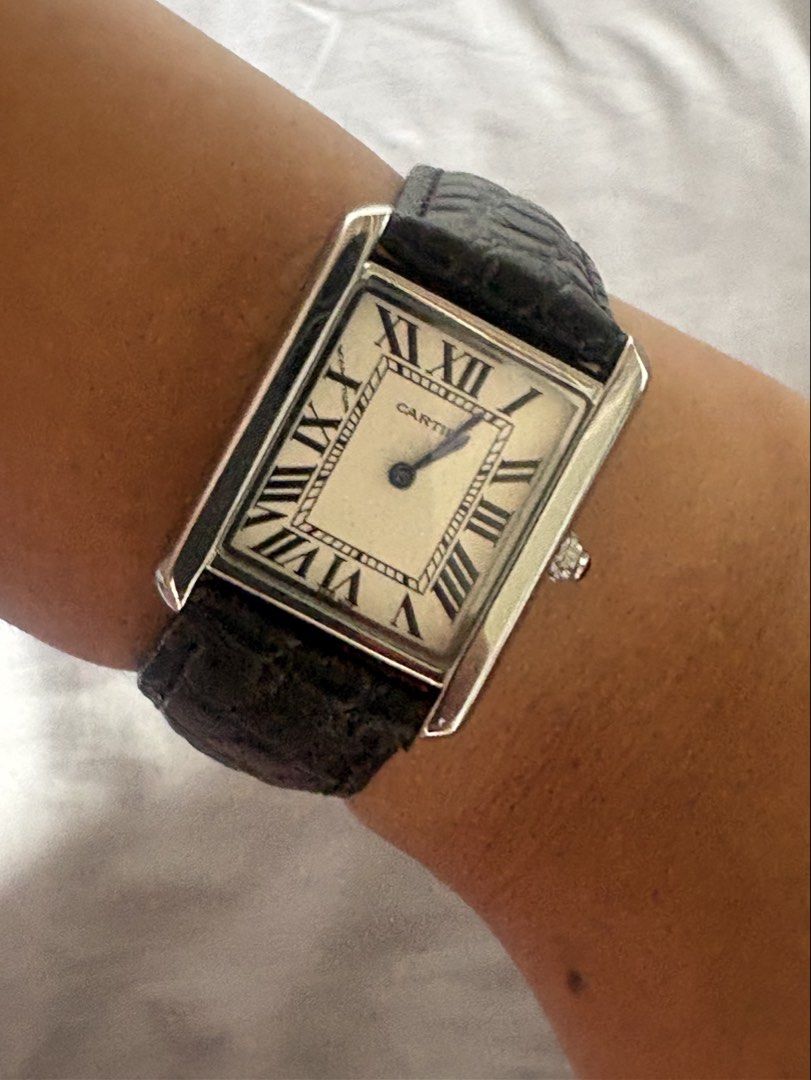 Cartier Tank Watch (Category: Men's Watches) located in Manila. Submitted by mndoxajc (Listing ID 1466064228, Image 2). Description: Stainless steel Cartier Tank watch with white dial and Roman numerals. Black embossed leather strap attached. Blue hands and blue cabochon crown. Case back engraved with Cartier, water resistant, swiss made, stainless steel, and model number 216. Genuine leather stamped on the inner strap. Minimal signs of wear..