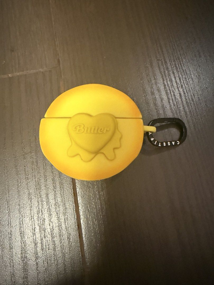 CASETiFY BTS Butter AirPods Case (Category: K-Wave Merchandise) located in Marikina City. Submitted by culose (Listing ID 1466492956, Image 1). Description: - Authentic BTS Butter x CASETiFY collaboration - Vibrant yellow silicone material protects against drops and scratches - Features an adorable raised heart design with the iconic Butter logo - Comes with a stylish black branded carabiner clip for easy carrying - Designed to fit standard AirPo
