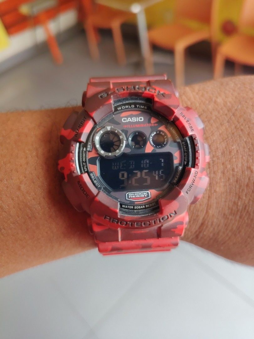 Casio G-Shock Red Camouflage Digital Watch (Category: Men's Watches) located in Las Pinas. Submitted by mitchellestrada20202020 (Listing ID 1466561253, Image 1). Description: - Brand: Casio G-Shock - Design: Bold red and dark red camo pattern - Display: Digital showing day, date, and time - Key Features: World Time, Illuminator, and 20bar Water Resist - Build: Heavy-duty chunky resin with a secure metal buckle - Style: Tactical timepiece, perfect