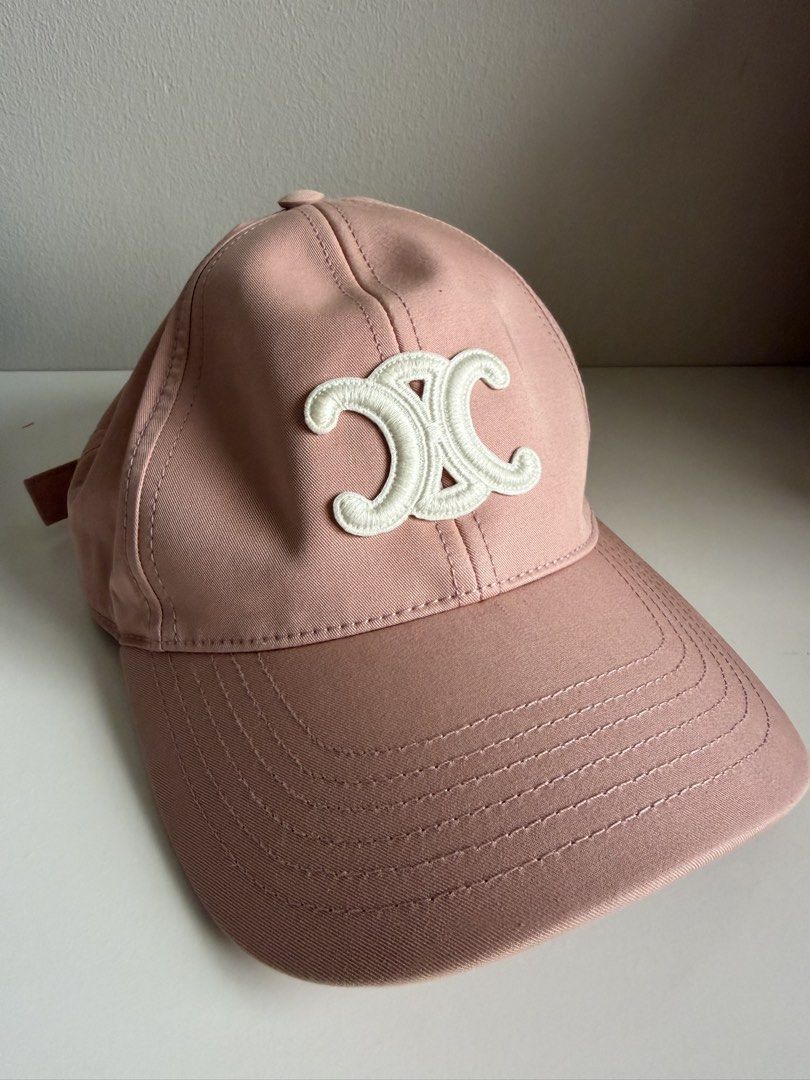 Celine Triomphe Baseball Cap in Cotton Pink Size S (Category: Caps & Hats) located in Makati City. Submitted by lovedbyalexis_ (Listing ID 1466376536, Image 2). Description: - 100% Authentic Celine baseball cap - Color: Soft pink cotton twill with off-white embroidered Triomphe logo - Size: S - Style: Classic 6-panel construction with curved brim - Condition: Excellent, comes with internal brand tags - Perfect for elevating your casual daily fits