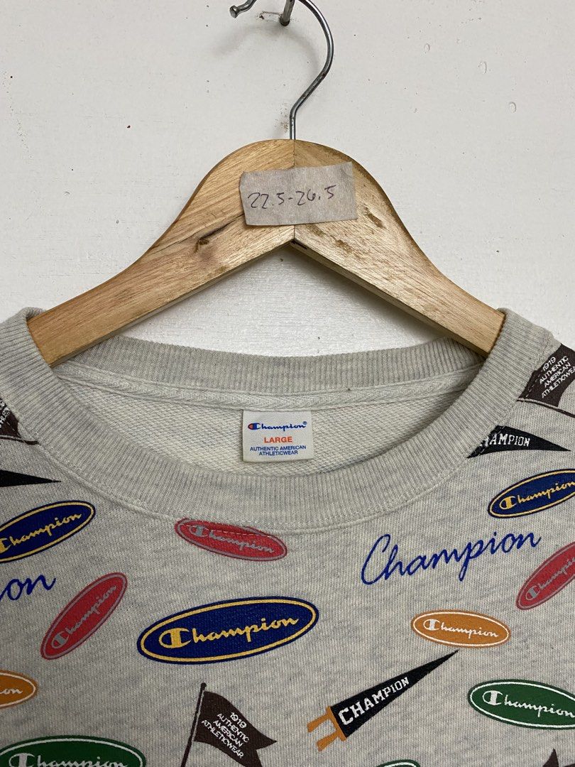 Champion All-Over Print Sweatshirt Gray Size Large (Category: Coats, Jackets and Outerwear) located in Cagayan de Oro. Submitted by stllht (Listing ID 1466450562, Image 3). Description: - Brand: Champion - Style: Crewneck sweatshirt with all-over vintage logo and pennant graphics - Color: Heather Gray - Size: Large - Dimes: 22x26.5 - Material: Cotton and polyester blend - Origin: Made in Cambodia - Condition: Great casual piece, bold retro design