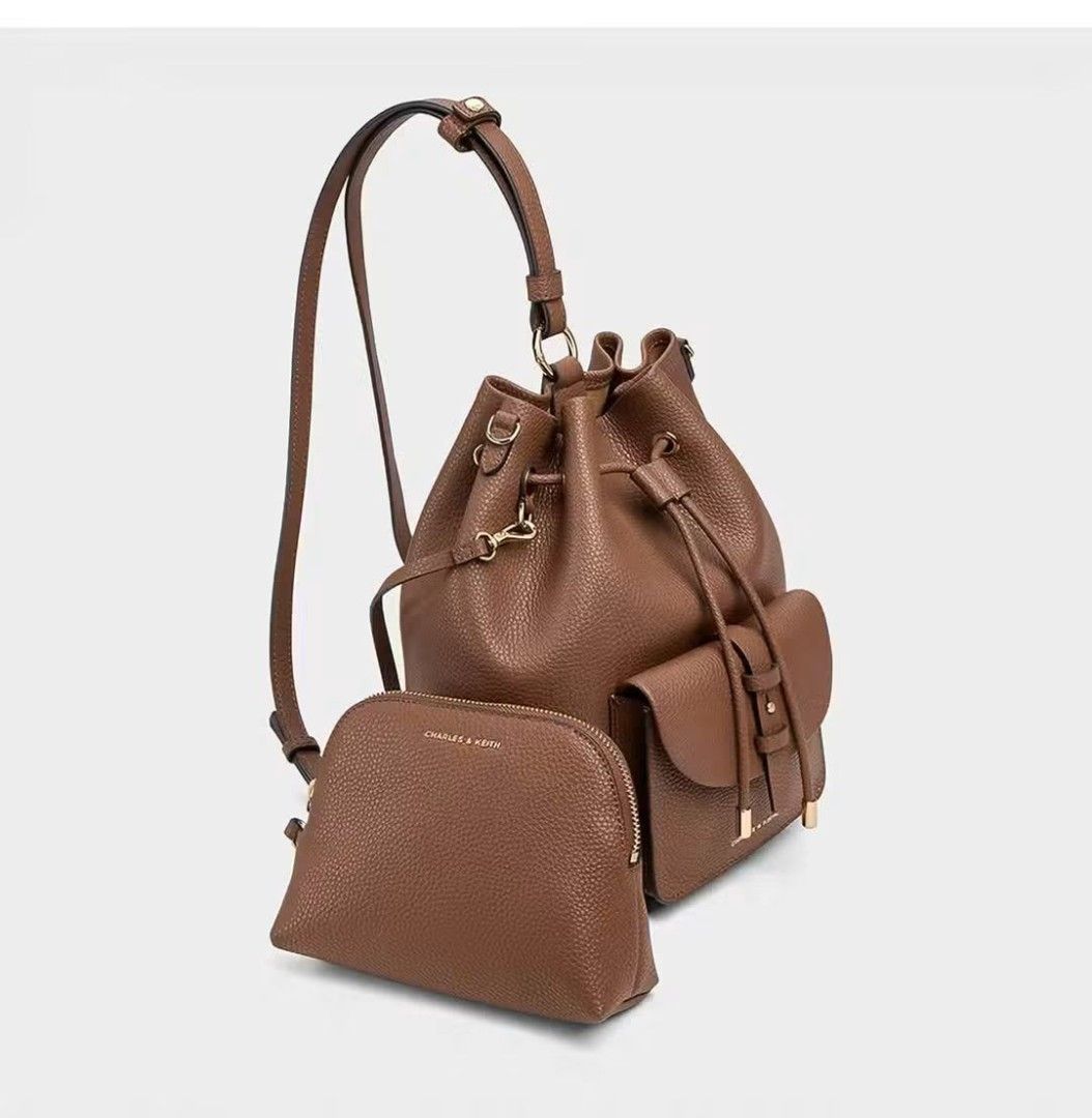Charles & Keith Beryl Drawstring Backpack for women Original (Category: Luxury Bags & Wallets) located in Mandaluyong City. Submitted by apparel_jenjo (Listing ID 1466390140, Image 2). Description: Key Design Features • Silhouette: A softly structured, classic bucket-style backpack crafted from a textured faux leather (PU) grain. • Closures & Pockets: It features a main drawstring closure with metallic-tipped cords and a prominent belted front po