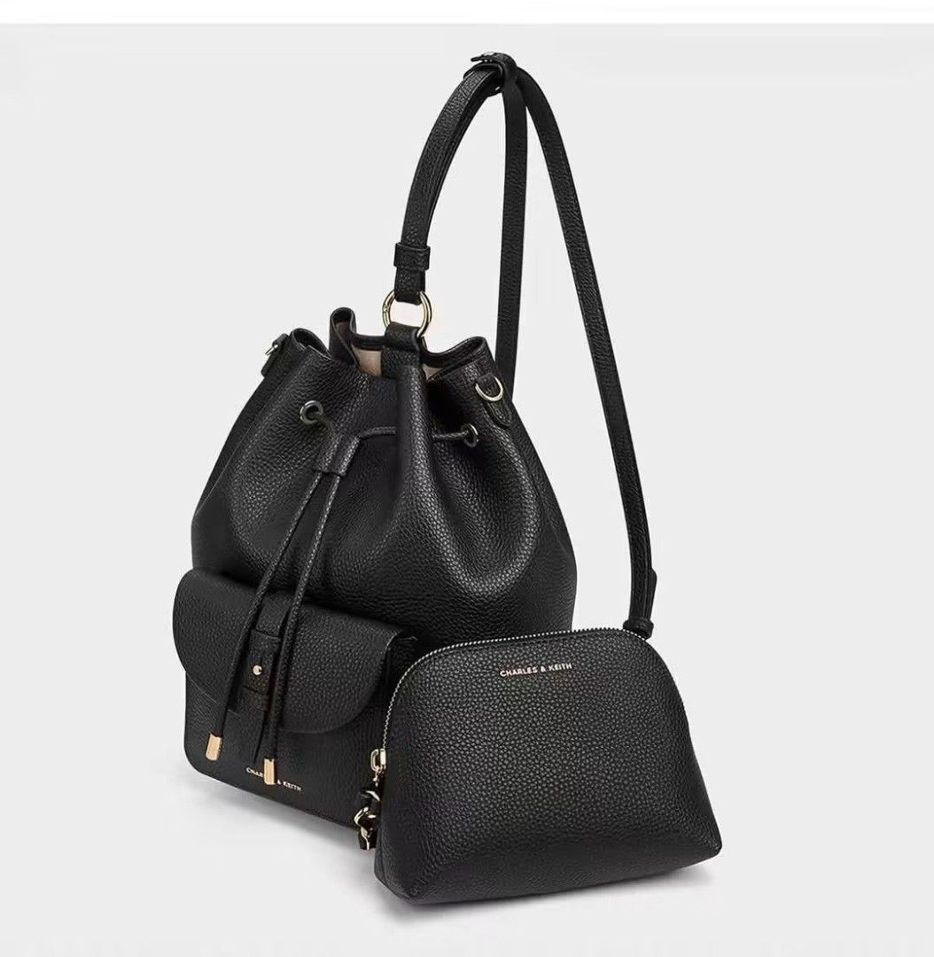 Charles & Keith Beryl Drawstring Backpack for women Original (Category: Luxury Bags & Wallets) located in Mandaluyong City. Submitted by apparel_jenjo (Listing ID 1466390140, Image 3). Description: Key Design Features • Silhouette: A softly structured, classic bucket-style backpack crafted from a textured faux leather (PU) grain. • Closures & Pockets: It features a main drawstring closure with metallic-tipped cords and a prominent belted front po