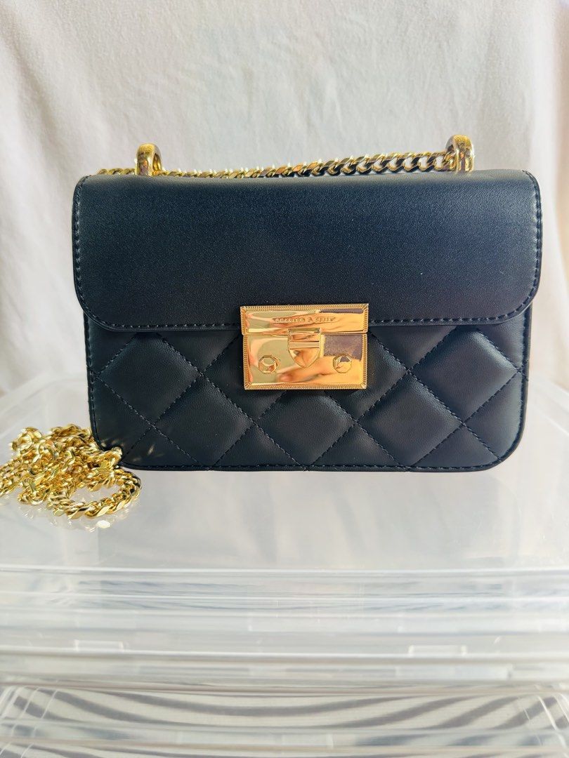 Charles & Keith Black Quilted Shoulder Bag (Category: Cross-body Bags) located in Pagsanjan. Submitted by lavishbyji22912 (Listing ID 1466362854, Image 1). Description: Authentic Charles & Keith bag Super like new papasa brand new No dustbag pero i provided a new one Rfs: d ko na ginagamit Classic black color Quilted diamond pattern Stylish gold-tone hardware Gold chain shoulder strap Front flap with secure clasp closure Compact yet spacious enou