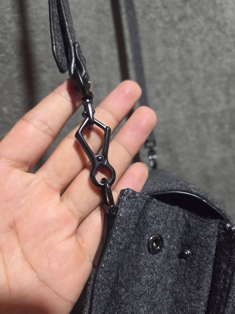 Charles & Keith Grey Felt Bow Crossbody Bag (Category: Cross-body Bags) located in Kidapawan. Submitted by azythrift (Listing ID 1466466379, Image 3). Description: - Brand: Charles & Keith - Color: Elegant grey felt - Design: Large statement bow on front flap with dark gunmetal hardware - Features: Adjustable and detachable shoulder strap with lobster clasps, side snap buttons for adjustable width - Shape: Compact rectangular shape with clean fab