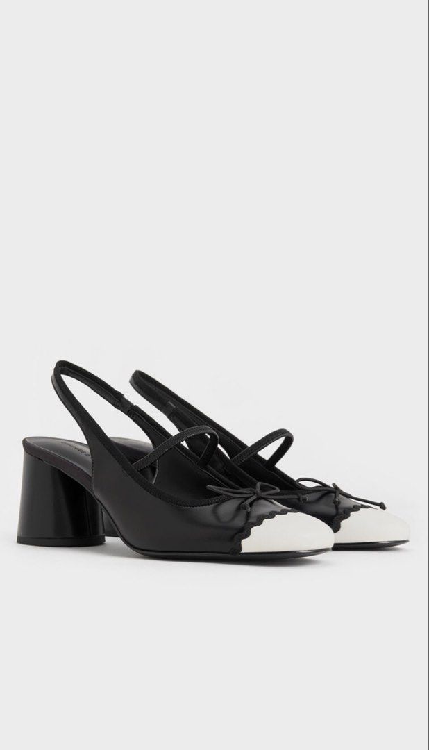 Charles & Keith Two-Tone Slingback Block Heels (Category: Heels) located in Manila. Submitted by yourclosetmnl_ (Listing ID 1466494385, Image 2). Description: - Brand: Charles & Keith - Style: Black and white slingback heels with Mary Jane strap and front bow detail - Design: Contrast white cap toe, scalloped trim, and classic round toe - Heel: Low block heel for comfortable all-day walking - Fit: Elasticated slingback strap for easy wear - Condi