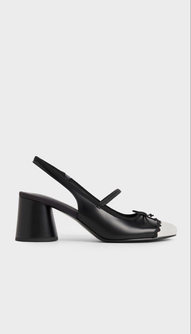 Charles & Keith Two-Tone Slingback Block Heels (Category: Heels) located in Manila. Submitted by yourclosetmnl_ (Listing ID 1466494385, Image 3). Description: - Brand: Charles & Keith - Style: Black and white slingback heels with Mary Jane strap and front bow detail - Design: Contrast white cap toe, scalloped trim, and classic round toe - Heel: Low block heel for comfortable all-day walking - Fit: Elasticated slingback strap for easy wear - Condi