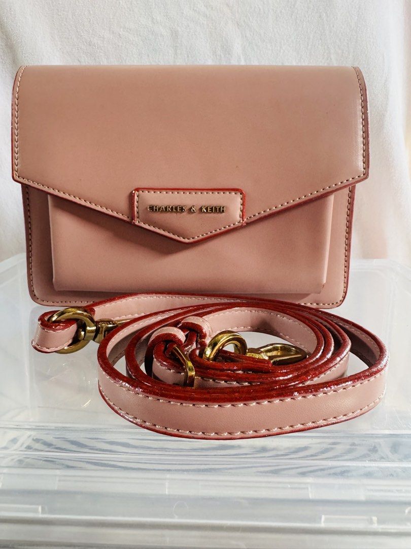 CHARLES AND KEITH BAG (Category: Cross-body Bags) located in Pagsanjan. Submitted by lavishbyji22912 (Listing ID 1466361887, Image 1). Description: Authentic Charles & Keith bag Super like new papasa brand new No dustbag pero i provided a new one Rfs: d ko na ginagamit Soft blush pink color Envelope flap style Gold-tone hardware and logo Adjustable/removable crossbody strap Compact yet stylish Pls pm if interested .