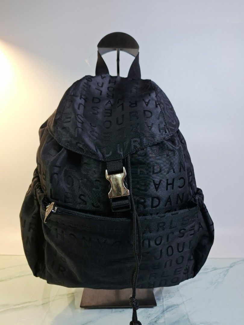 Charles Jourdan Paris Black Monogram Nylon Backpack (Category: Backpacks) located in Pasay City. Submitted by onick_79 (Listing ID 1466498737, Image 1). Description: - Brand: Charles Jourdan - Color: Classic Black with all-over debossed monogram pattern - Material: Lightweight and durable nylon - Closure: Top flap with buckle and drawstring pull - Storage: Front zipper pocket for quick access and a clean interior - Straps: Adjustable shoulder str