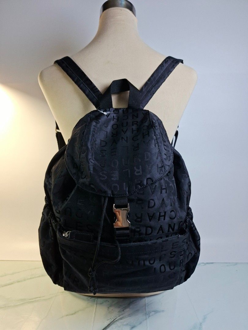 Charles Jourdan Paris Black Monogram Nylon Backpack (Category: Backpacks) located in Pasay City. Submitted by onick_79 (Listing ID 1466498737, Image 3). Description: - Brand: Charles Jourdan - Color: Classic Black with all-over debossed monogram pattern - Material: Lightweight and durable nylon - Closure: Top flap with buckle and drawstring pull - Storage: Front zipper pocket for quick access and a clean interior - Straps: Adjustable shoulder str