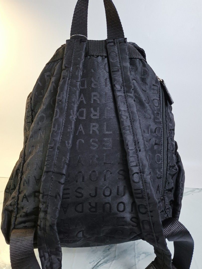 Charles Jourdan Paris Black Monogram Nylon Backpack (Category: Backpacks) located in Pasay City. Submitted by onick_79 (Listing ID 1466498737, Image 2). Description: - Brand: Charles Jourdan - Color: Classic Black with all-over debossed monogram pattern - Material: Lightweight and durable nylon - Closure: Top flap with buckle and drawstring pull - Storage: Front zipper pocket for quick access and a clean interior - Straps: Adjustable shoulder str