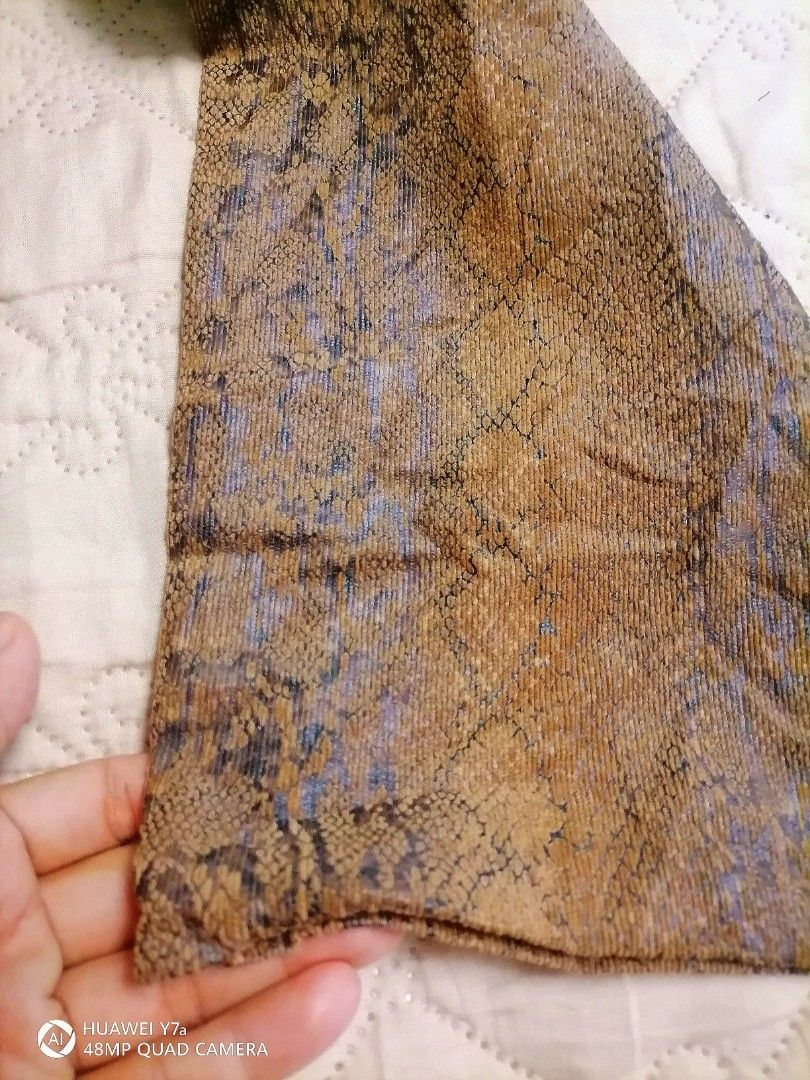 Chico's Snake Print Brown Pants Size 1.5 (Category: Jeans) located in Naga. Submitted by mrwisethrifter (Listing ID 1466358792, Image 2). Description: Chico's trousers in a brown and black snakeskin print. Textured corduroy-like fabric with some stretch. Size 1.5 tag on the inside waistband. Button closure with zip fly, front pockets, and two back pockets with metal rivets. Made in China, 54% polyester blend. Straight leg cut..