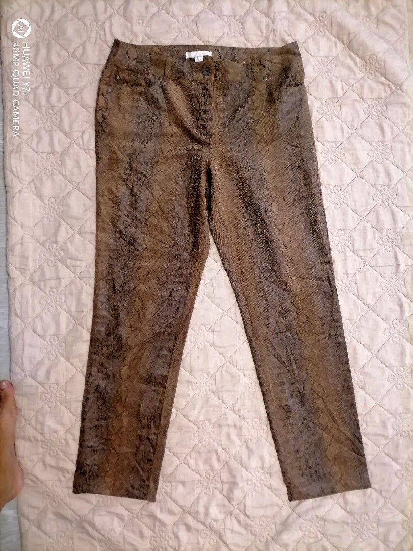 Chico's Snake Print Brown Pants Size 1.5 (Category: Jeans) located in Naga. Submitted by mrwisethrifter (Listing ID 1466358792, Image 1). Description: Chico's trousers in a brown and black snakeskin print. Textured corduroy-like fabric with some stretch. Size 1.5 tag on the inside waistband. Button closure with zip fly, front pockets, and two back pockets with metal rivets. Made in China, 54% polyester blend. Straight leg cut..