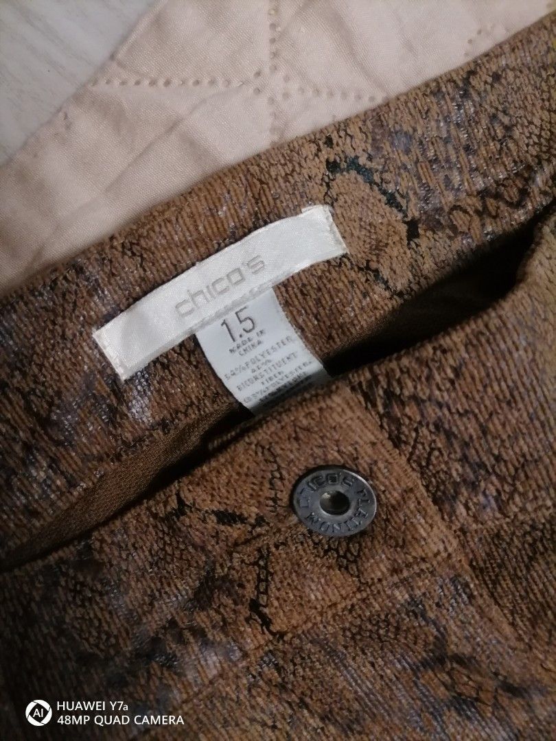 Chico's Snake Print Brown Pants Size 1.5 (Category: Jeans) located in Naga. Submitted by mrwisethrifter (Listing ID 1466358792, Image 3). Description: Chico's trousers in a brown and black snakeskin print. Textured corduroy-like fabric with some stretch. Size 1.5 tag on the inside waistband. Button closure with zip fly, front pockets, and two back pockets with metal rivets. Made in China, 54% polyester blend. Straight leg cut..