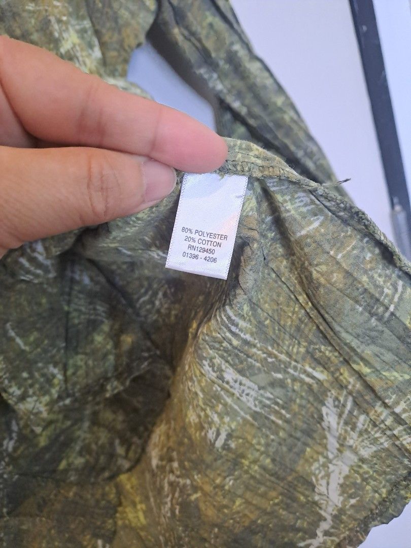 Christopher Banks green (Category: Longsleeves) located in Manila. Submitted by joanbalde39643 (Listing ID 1466438826, Image 3). Description: This item is a Christopher & Banks women's green crinkle button-up blouse featuring a textured, puckered fabric and a rustic, abstract camouflage or marbled print pattern.