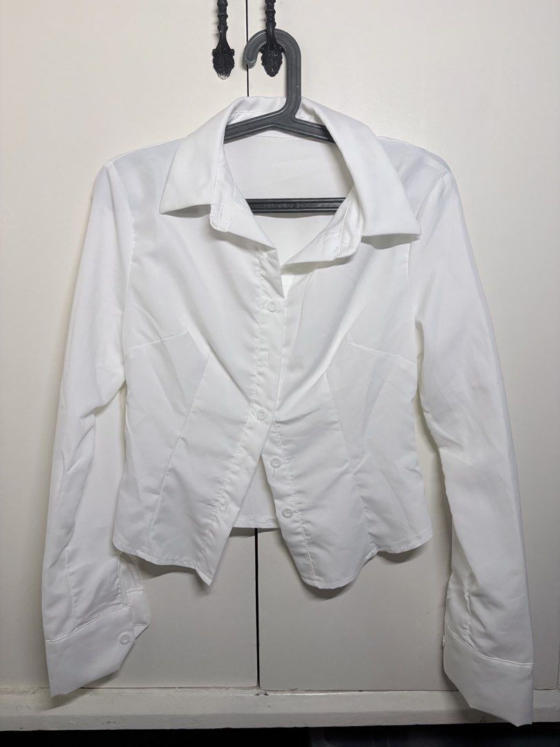 Cinched White Long-Sleeve Collared Top (Category: Longsleeves) located in Paranaque City. Submitted by honeykkkk (Listing ID 1466475626, Image 1). Description: • Details: Classic spread collar, front button closures, waist-cinching seam details for a flattering silhouette, long sleeves with wide buttoned cuffs. Perfect for preppy, Y2K, or smart-casual outfits. • Condition: Like new — tried on once to fit, but never worn. • Original Price: PHP 398