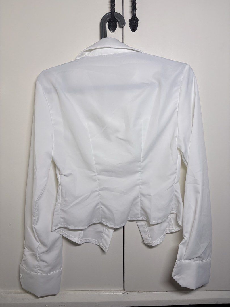 Cinched White Long-Sleeve Collared Top (Category: Longsleeves) located in Paranaque City. Submitted by honeykkkk (Listing ID 1466475626, Image 2). Description: • Details: Classic spread collar, front button closures, waist-cinching seam details for a flattering silhouette, long sleeves with wide buttoned cuffs. Perfect for preppy, Y2K, or smart-casual outfits. • Condition: Like new — tried on once to fit, but never worn. • Original Price: PHP 398