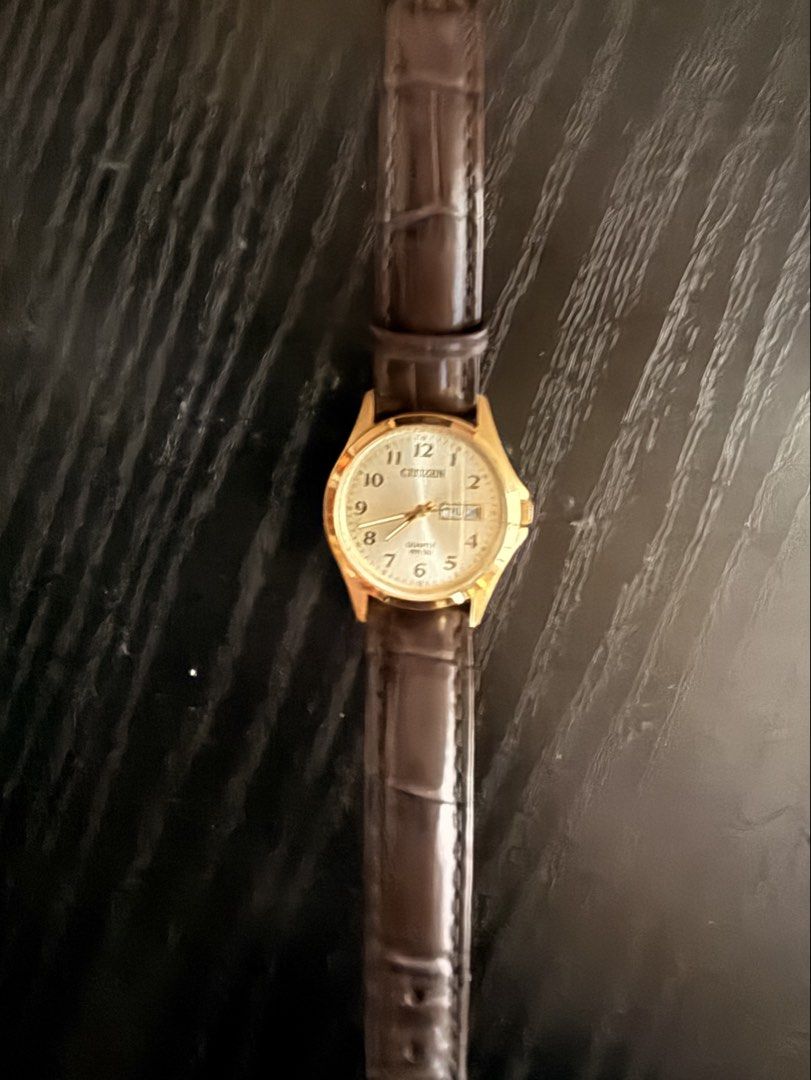 Citizen Ladies Watch EQ2002-07P (Category: Women's Watches) located in Manila. Submitted by jdeaellaaaa (Listing ID 1466563171, Image 3). Description: - Brand/Model: Citizen EQ2002-07P Ladies Watch - Design: Elegant gold-tone case with a dark brown leather strap - Dial: Classic champagne dial with easy-to-read Arabic numerals - Features: Convenient day-date window at the 3 o'clock position - Movement: Reliable quartz movement - Water Resistance: 