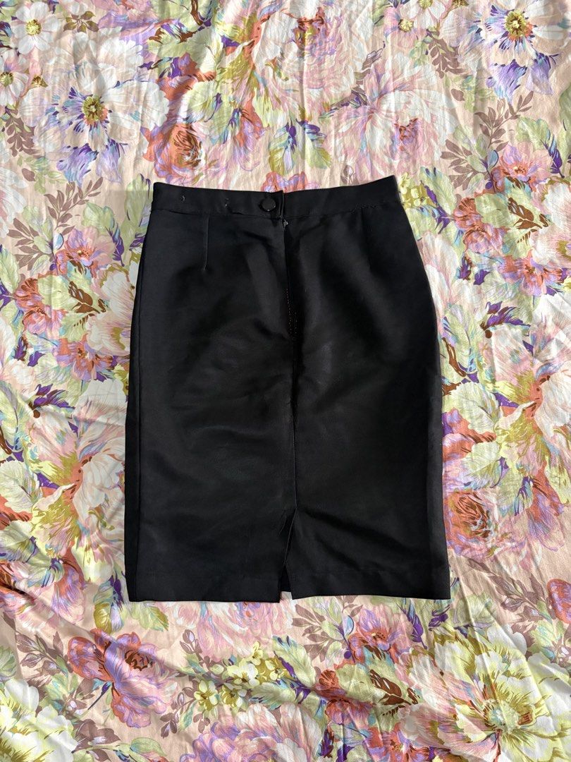 Classic Black Pencil Skirt (Category: Skirts) located in Paranaque City. Submitted by delikaite (Listing ID 1466396449, Image 2). Description: - Style: Classic black pencil skirt - Length: Knee-length with straight hem and back slit - Details: Solid black fabric with waistband button closure - Condition: Great basic piece for work/formal wear, featuring a small mended repair near the front zipper using pink thread - Versatility: Easy to pair with