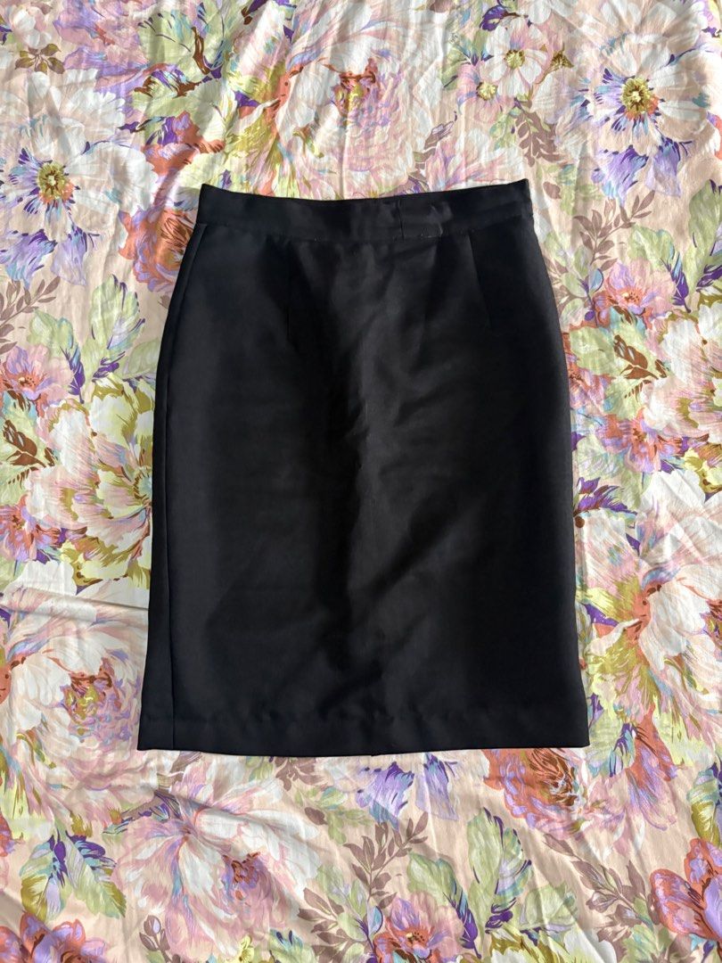 Classic Black Pencil Skirt (Category: Skirts) located in Paranaque City. Submitted by delikaite (Listing ID 1466396449, Image 1). Description: - Style: Classic black pencil skirt - Length: Knee-length with straight hem and back slit - Details: Solid black fabric with waistband button closure - Condition: Great basic piece for work/formal wear, featuring a small mended repair near the front zipper using pink thread - Versatility: Easy to pair with