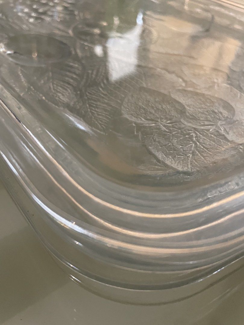 Clear Glass Serving Tray with Embossed Fruit Pattern (Category: Dinnerware & Cutlery) located in Cebu City. Submitted by modelrunway (Listing ID 1466410404, Image 3). Description: - Clear glass serving tray with embossed fruit and leaf designs (grapes, strawberries, pear, plum) - Heavy and durable glass construction with raised edges - Multi-use: ideal for serving food or organizing items on a table - Condition: Excellent, inspected with no chips
