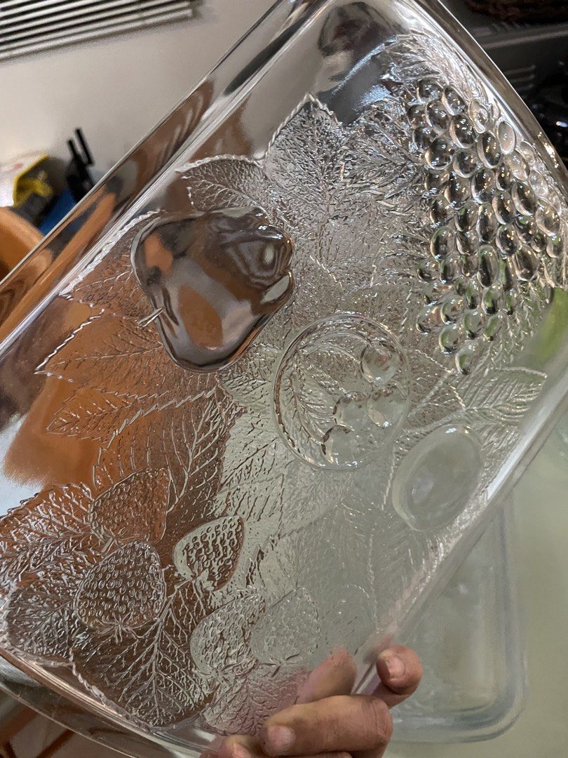 Clear Glass Serving Tray with Embossed Fruit Pattern (Category: Dinnerware & Cutlery) located in Cebu City. Submitted by modelrunway (Listing ID 1466410404, Image 2). Description: - Clear glass serving tray with embossed fruit and leaf designs (grapes, strawberries, pear, plum) - Heavy and durable glass construction with raised edges - Multi-use: ideal for serving food or organizing items on a table - Condition: Excellent, inspected with no chips