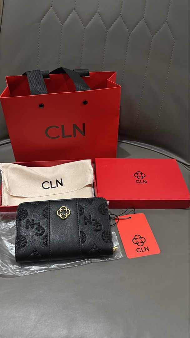 CLN Black Bi-Fold Wallet (Category: Wallets & Card holders) located in Manila. Submitted by roxiee7878 (Listing ID 1466351982, Image 2). Description: - Brand: CLN - Color: Classic Black - Design: Chic debossed monogram surface with elegant gold-tone hardware accent - Storage: Multiple card slots and a secure zippered coin compartment - Condition: Brand new with store tag attached - Inclusions: Complete set with original red gift box, dust bag, an
