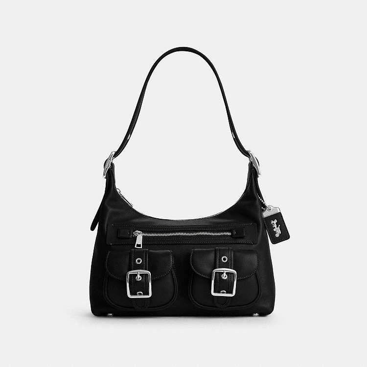 Coach Allison Zip Top Shoulder Bag in Black (Category: Shoulder Bags) located in Las Pinas. Submitted by shopwithmira13 (Listing ID 1466562697, Image 2). Description: - Brand: Coach - Style: Y2K utilitarian shoulder bag - Material: Black leather with clean dark interior lining - Hardware: Silver-tone buckles and zip-top closure - Features: Front utility pockets, top handle strap, and Coach hangtag - Branding: Coach logo lettering near the base on
