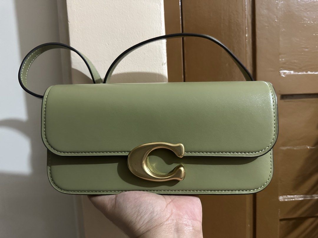 Coach Idol 23 bag (Category: Luxury Bags & Wallets) located in Manila. Submitted by kimmmmy_ (Listing ID 1466550485, Image 1). Description: - Brand: Coach - Model: Idol 23 Bag - Color: Olive Green - Hardware: Gold-tone 'C' clasp - Style: Shoulder bag / handbag with top handle - Condition: Well-maintained and gently used (layered condition 7) - Meetup locations: SM Megamall, Guevent Pickle Club, Robinsons Supermarket California Gardens Mandaluyong