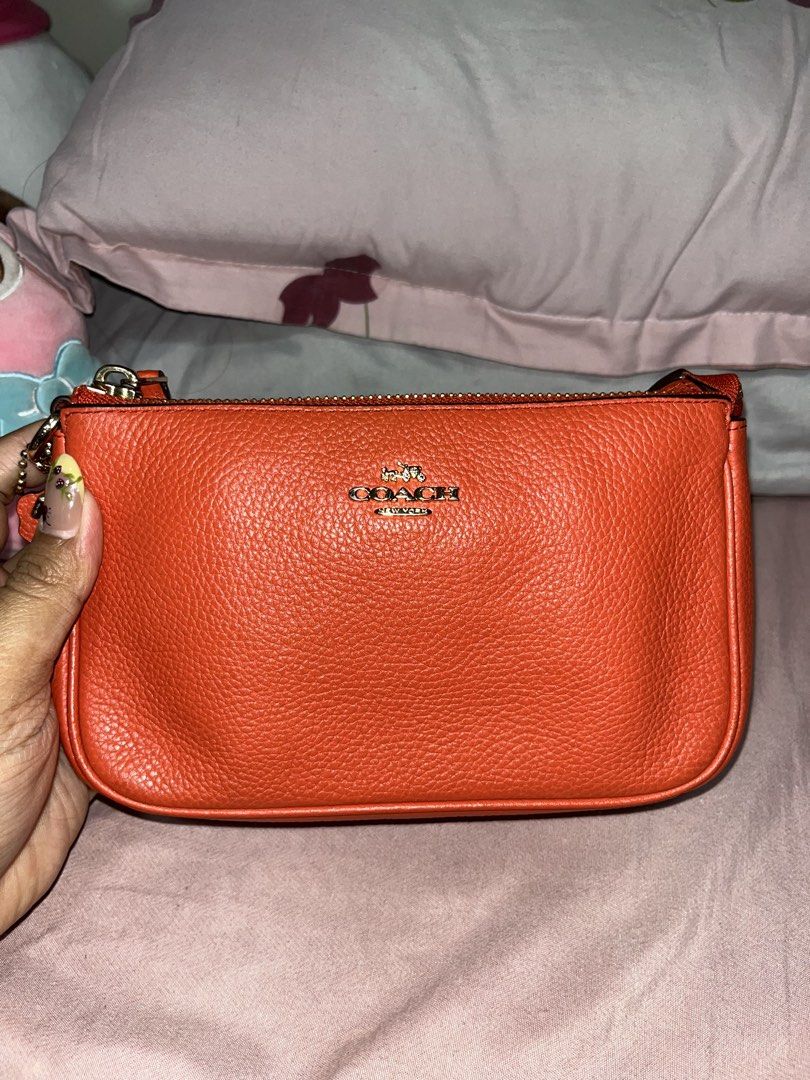 Coach Orange Leather Shoulder Bag with Gold Chain (Category: Luxury Bags & Wallets) located in Liloan. Submitted by sakurumifinds2809 (Listing ID 1466427607, Image 3). Description: Bright orange pebble leather Coach shoulder bag. Gold chain strap and hardware. Zip top closure. Classic Coach logo stamped in gold on the front. Clean pebbled texture. Compact size for daily essentials..