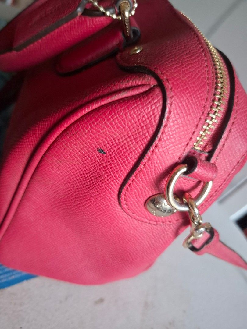 Coach Pink Leather Satchel Handbag (Category: Luxury Bags & Wallets) located in Marikina City. Submitted by bags21.ph (Listing ID 1466336972, Image 2). Description: - Brand: Coach - Style: Crossgrain leather satchel - Color: Bright pink with gold hardware - Features: Double top handles, adjustable strap, zip top closure, fabric lining, and matching hangtag - Authenticity: Creed patch No. A1732-F57521, Made in Philippines - Condition: Good overall