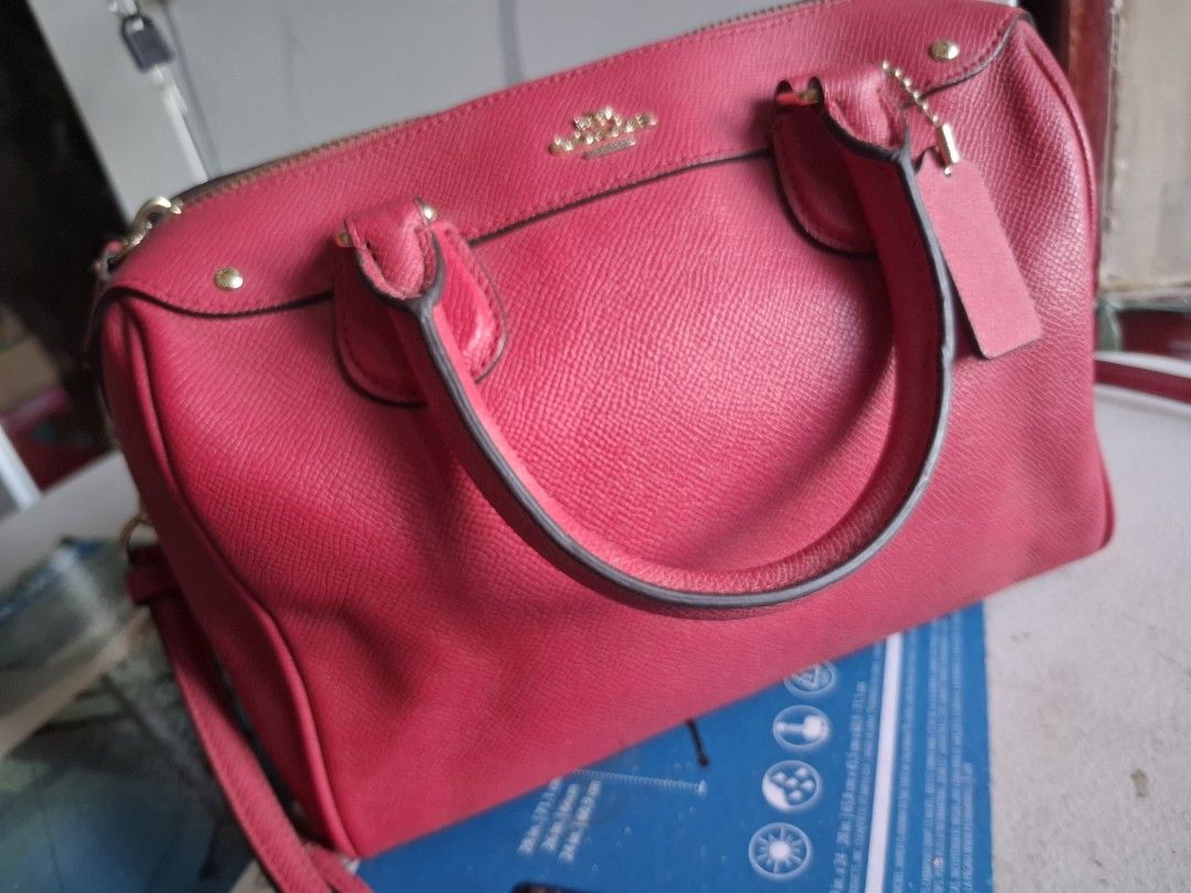 Coach Pink Leather Satchel Handbag (Category: Luxury Bags & Wallets) located in Marikina City. Submitted by bags21.ph (Listing ID 1466336972, Image 1). Description: - Brand: Coach - Style: Crossgrain leather satchel - Color: Bright pink with gold hardware - Features: Double top handles, adjustable strap, zip top closure, fabric lining, and matching hangtag - Authenticity: Creed patch No. A1732-F57521, Made in Philippines - Condition: Good overall