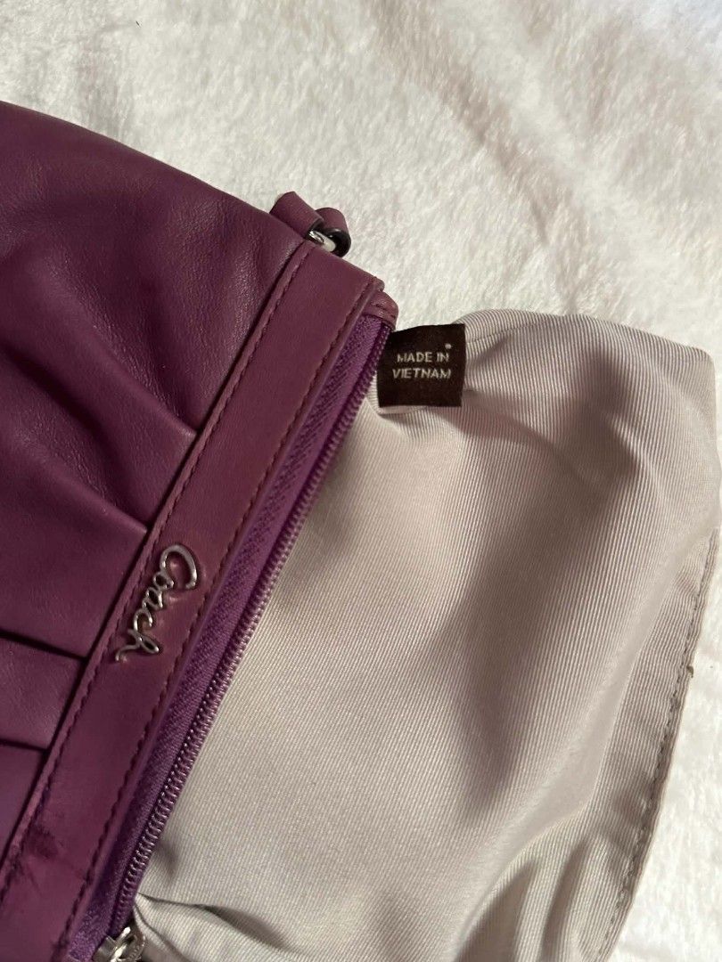 Coach Purple Leather Wristlet Handbag (Category: Luxury Bags & Wallets) located in Pasacao. Submitted by kishhuschka (Listing ID 1466429376, Image 3). Description: - Brand: Coach -Authentic 💯 - Color: Rich purple leather with light grey fabric lining - Design: Stylish ruched front with silver-toned metal Coach logo and hardware - Closure & Strap: Secure zip top closure with a convenient detachable wrist strap - Interior: Compact size ideal for c
