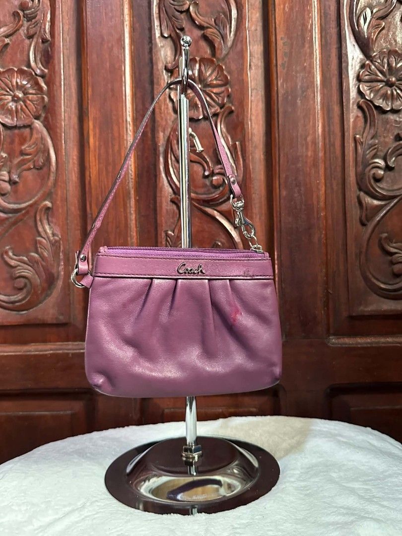 Coach Purple Leather Wristlet Handbag (Category: Luxury Bags & Wallets) located in Pasacao. Submitted by kishhuschka (Listing ID 1466429376, Image 1). Description: - Brand: Coach -Authentic 💯 - Color: Rich purple leather with light grey fabric lining - Design: Stylish ruched front with silver-toned metal Coach logo and hardware - Closure & Strap: Secure zip top closure with a convenient detachable wrist strap - Interior: Compact size ideal for c