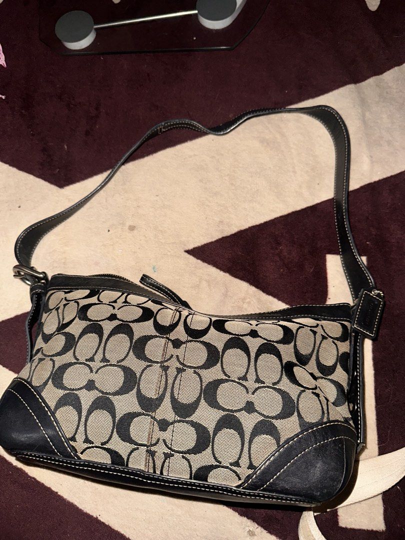 Coach Signature Black and Khaki Shoulder Bag (Category: Luxury Bags & Wallets) located in Manila. Submitted by saturnina89 (Listing ID 1466445865, Image 1). Description: - Authentic Coach signature C print fabric with stylish black leather trim - Secure top zipper closure and convenient exterior front zip pocket - Burgundy fabric-lined interior featuring a slip pocket and traditional creed patch - Comfortable, adjustable black leather shoulder st