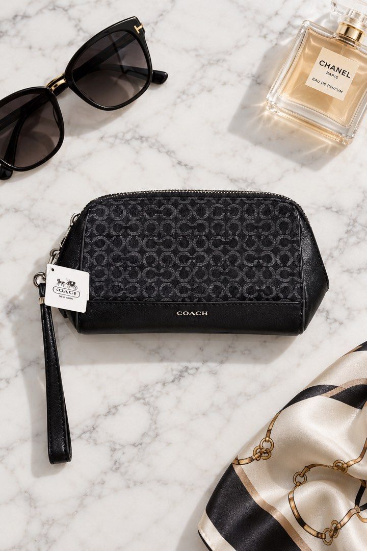 Coach Signature Monogram Black Wristlet (Category: Sling Bags) located in Cebu City. Submitted by relovedfinds.ph (Listing ID 1466353062, Image 1). Description: Authentic Coach Signature Monogram Black Wristlet featuring the classic black signature monogram pattern, crafted from durable fabric with a leather bottom panel for added structure and style. It comes with elegant silver-tone hardware, a secure zip closure, and an attached wrist strap fo
