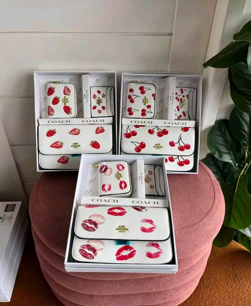 Coach White Patterned Wallet and Bag Gift Set (Category: Wallets & Card holders) located in Caloocan City. Submitted by caramelmacchiato555 (Listing ID 1466385557, Image 1). Description: - Authentic Coach matching white leather sets - 3 adorable prints available: Strawberries, Cherries, and Red Lips - Complete 3-in-1 set: Shoulder bag, matching wallet, and card holder - Comes in original white gift box - Ideal for everyday use or as a luxurious g