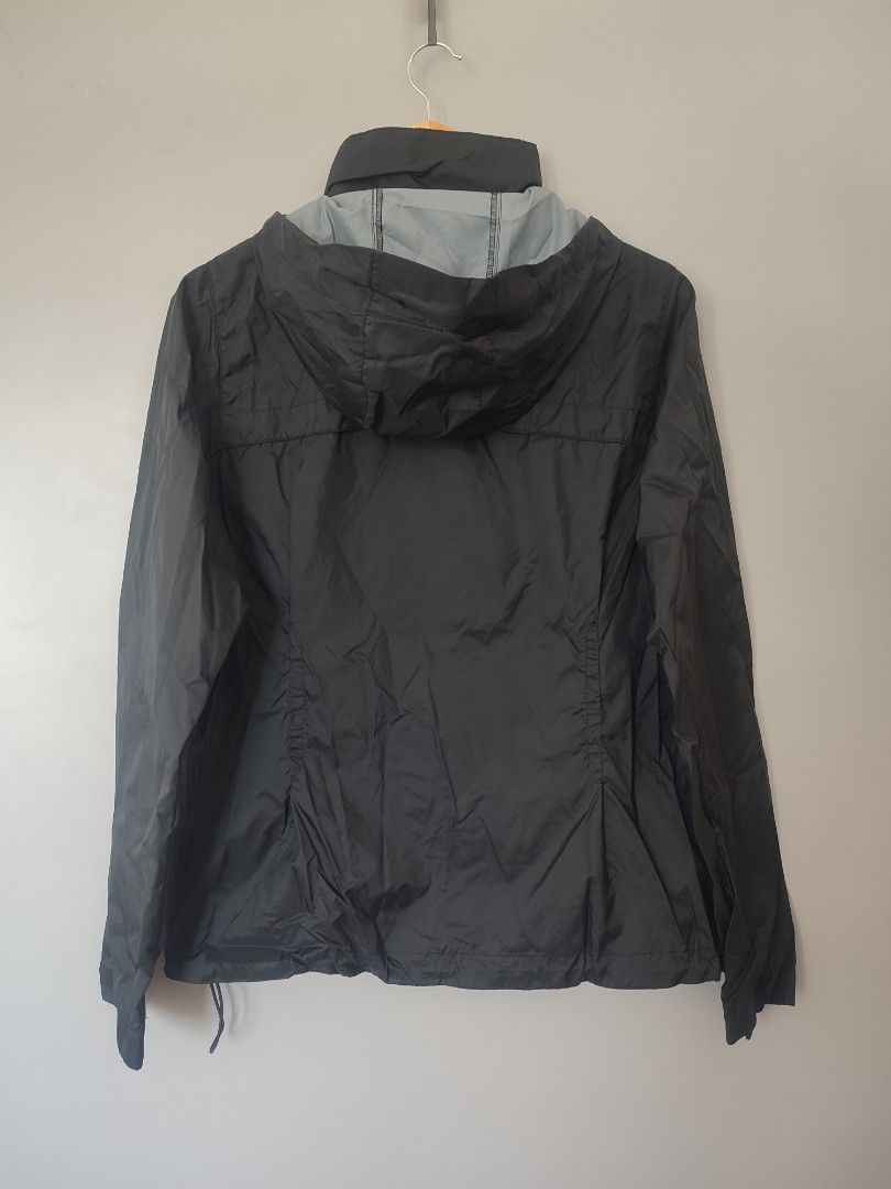 Columbia Black Packable Hooded Windbreaker Jacket Size M (Category: Coats, Jackets and Outerwear) located in Lipa City. Submitted by gudoys_outdoor16 (Listing ID 1466462461, Image 2). Description: - Brand: Columbia - Color: Solid black - Size: Women's standard sizing - Material & Lining: Lightweight with breathable grey mesh interior - Features: Full zip front, adjustable hood, and elastic cuffs - Packable: Folds neatly into its own integrated po