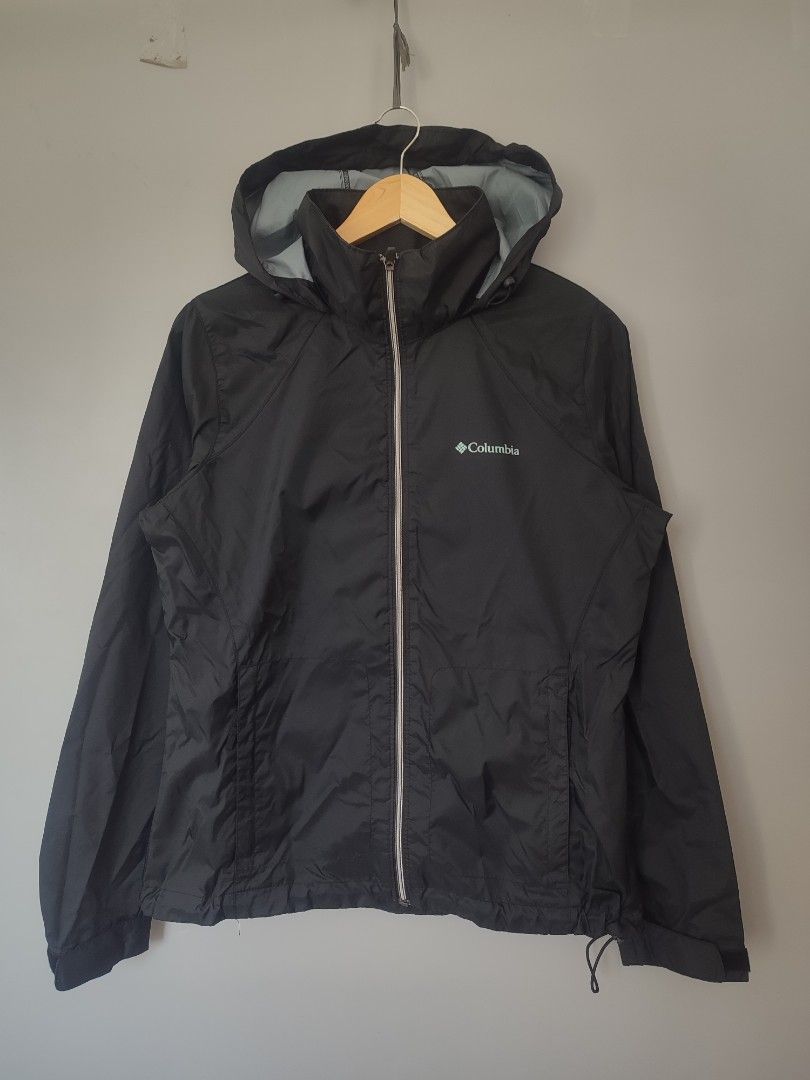 Columbia Black Packable Hooded Windbreaker Jacket Size M (Category: Coats, Jackets and Outerwear) located in Lipa City. Submitted by gudoys_outdoor16 (Listing ID 1466462461, Image 1). Description: - Brand: Columbia - Color: Solid black - Size: Women's standard sizing - Material & Lining: Lightweight with breathable grey mesh interior - Features: Full zip front, adjustable hood, and elastic cuffs - Packable: Folds neatly into its own integrated po