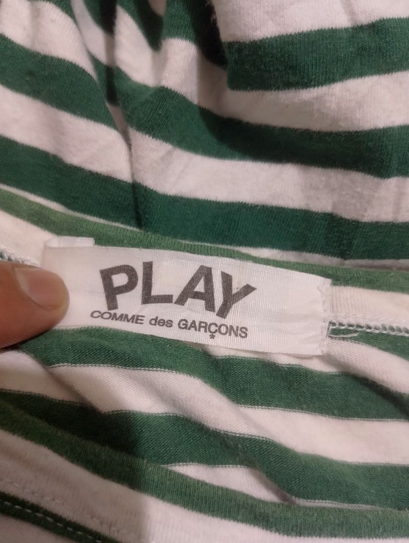 COMME des GARÇONS PLAY Striped Long Sleeve Tee (Category: Shirts) located in Cavite. Submitted by marvzclothing (Listing ID 1466463009, Image 3). Description: - Brand: COMME des GARÇONS PLAY - Design: Green and white striped long sleeve with iconic embroidered red heart logo - Material: 100% Cotton, Made in Japan - Neckline: Classic crew neck - Model: AZ-T005 - Care: Hand wash recommended - Condition: Guaranteed authentic, well-maintained.