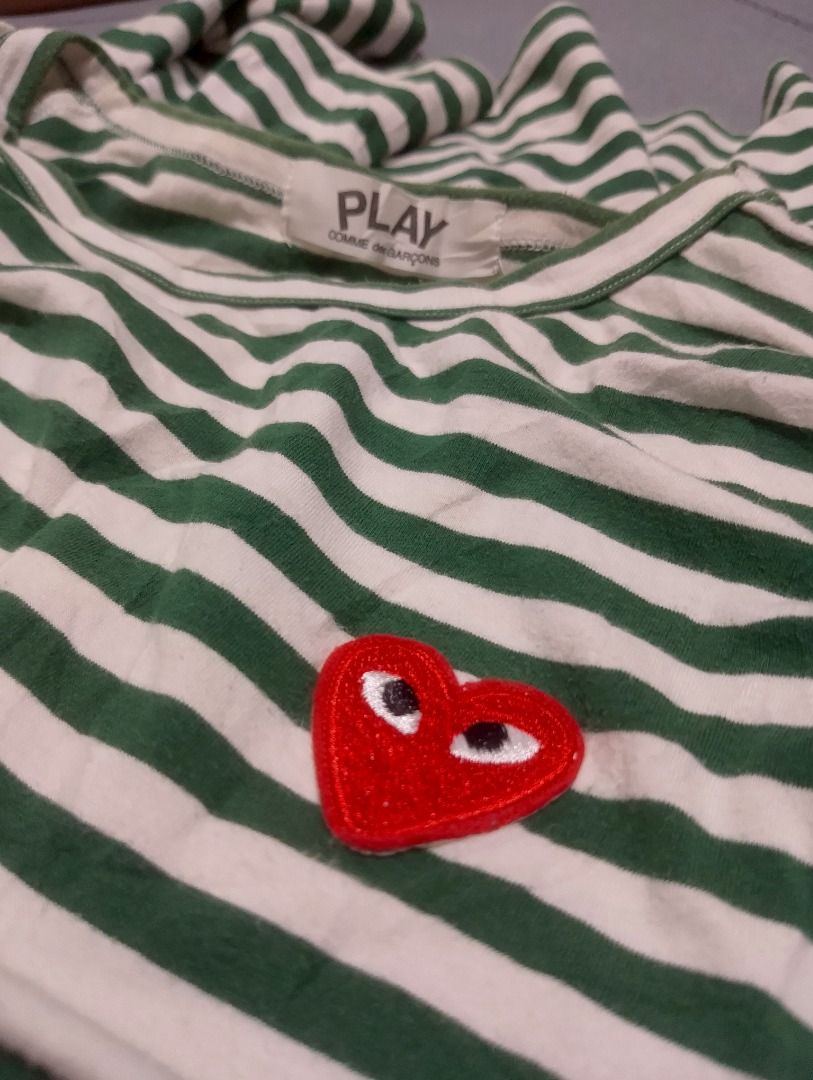 COMME des GARÇONS PLAY Striped Long Sleeve Tee (Category: Shirts) located in Cavite. Submitted by marvzclothing (Listing ID 1466463009, Image 2). Description: - Brand: COMME des GARÇONS PLAY - Design: Green and white striped long sleeve with iconic embroidered red heart logo - Material: 100% Cotton, Made in Japan - Neckline: Classic crew neck - Model: AZ-T005 - Care: Hand wash recommended - Condition: Guaranteed authentic, well-maintained.