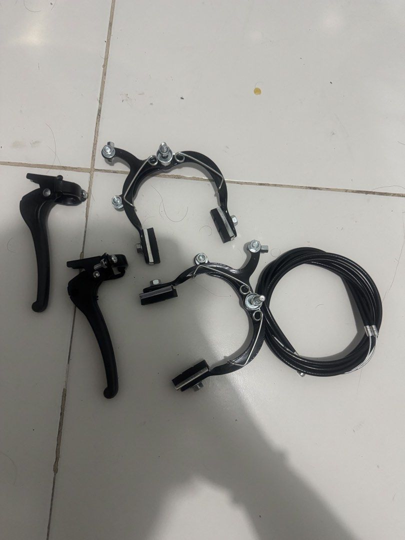 Complete Bicycle Caliper Brake Set with Levers and Cables (Category: Bicycles) located in Manila. Submitted by sulitmarka58060 (Listing ID 1466346236, Image 1). Description: - Complete bicycle brake kit ready for installation - Includes two black caliper brake arms with pre-attached pads - Comes with a pair of matching handlebar brake levers - Includes two black brake cables with housing - Clean parts with zero visible rust on metal hardware - Pe